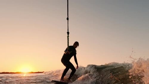 A Dynamic Sunset Surfing Experience Capturing the Thrill and Joy of Riding Waves with a Wakeboard