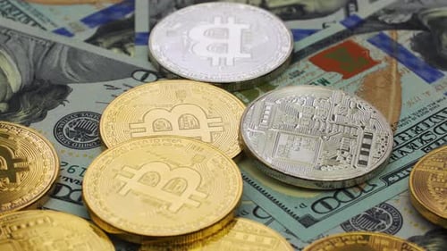 Gold and Silver Bitcoin Coins on US Currency