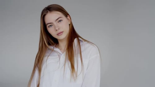 Young Woman Smiling in Studio with Auburn Hair