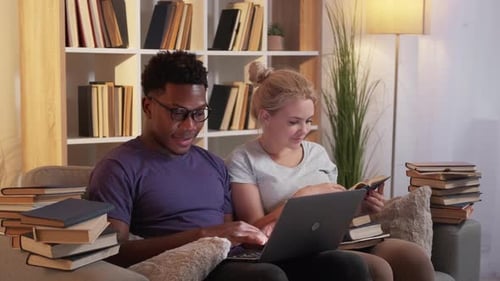 Couple Studying Together with Laptop and Books