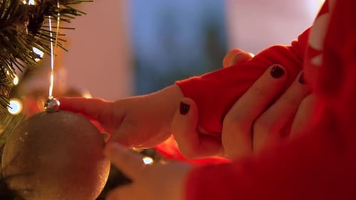 Adorable Baby Decorating Christmas Tree with Shiny Ornament