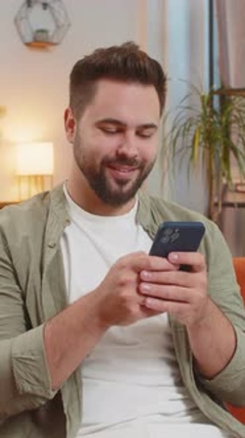 Man using a Mobile Phone in a Home Setting