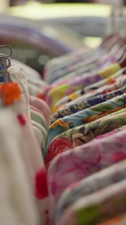 A Vibrant and Diverse Row of Colorful Garments Displayed on Hangers Gradually Transitioning to a