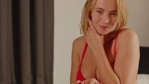 Attractive Blonde Woman Posing on Bed