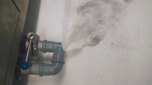 Dirty Soapy Water Flows Out of the Pipe at the Factory Chemical Pollution