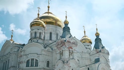Low angle view of a beautiful white church on a blue cloudy sky background