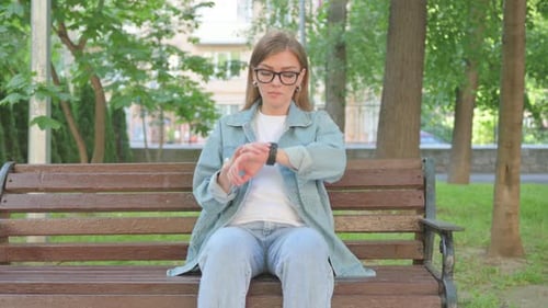 Waiting Casual Woman Checking Wrist Watch on Park Bench