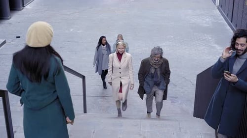 Adults Walking Up Stairs in Urban City