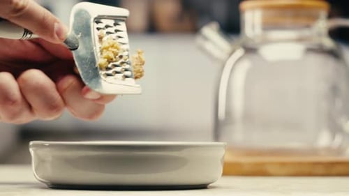 Woman Grating Ginger on Black Background Grater with Ginger for Healthy Tea Lemonade