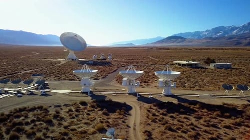 Aerial view of multiple satellite arrays, at a desert in USA - tracking, drone shot