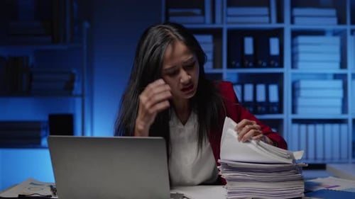 Businesswoman is seriously stressed working overtime bored and burnout due to office syndrome