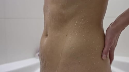 Close Up of Torso with Water Droplets in Shower