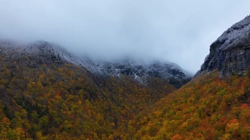 Autumn Mountains with Colorful Foliage and Snow