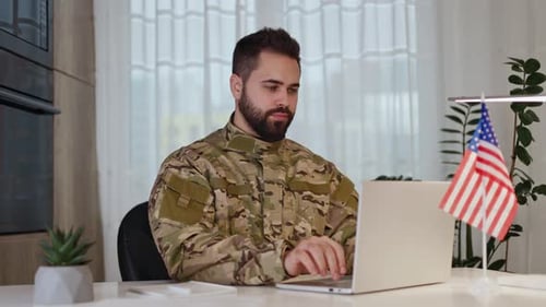 Focused American Soldier Sending Emails From Modern Computer at Domestic Office