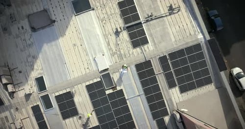 Solar panels, aerial and building man with blueprint for rooftop, architecture or grid design