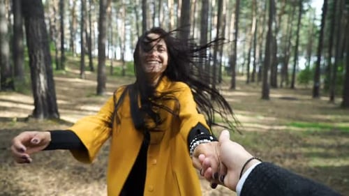 The Girl Leading a Man Forward to the Adventure. Follow Me Concept