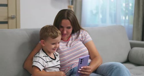 Woman and Child Enjoying Mobile Phone Together