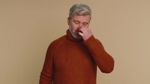 Adult Man Adjusts Eyeglasses Indoors