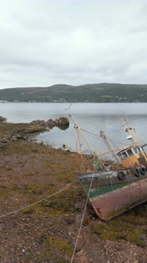 Aerial Drone of Abandoned Fishing Boat on Rocky Shore Scotland
