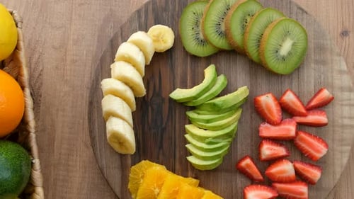 Blick von oben auf Panning Shot Fruits auf einem Holzteller