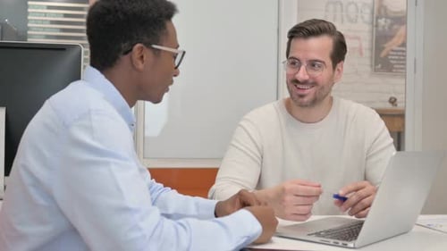 Businessman Talking with Businessman in Office