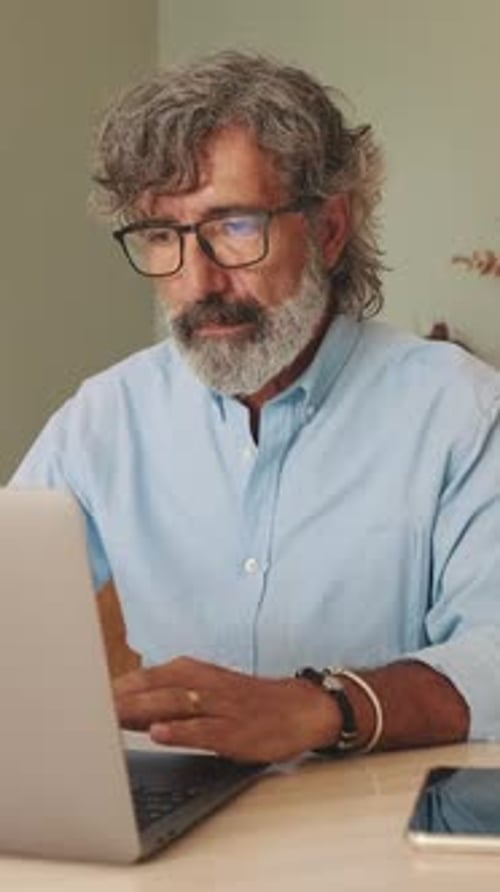 Man Working on Laptop at Home Office