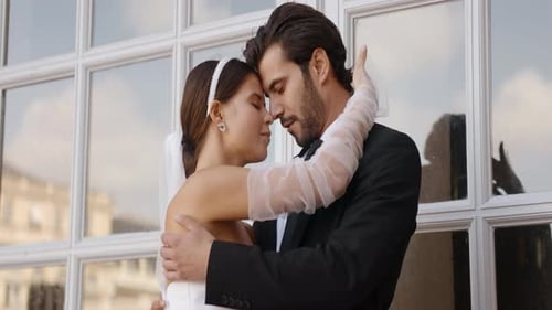 Romantic Wedding Couple Embrace Tenderly by a Window