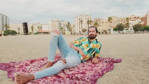 Young man relaxing on the beach