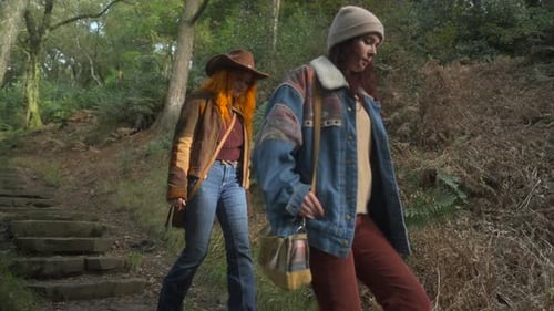 Two Women Walking Down Stone Path in Forest
