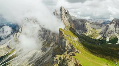Dense Fog Surrounds Giant Seceda Mountain Range on Sunny Day