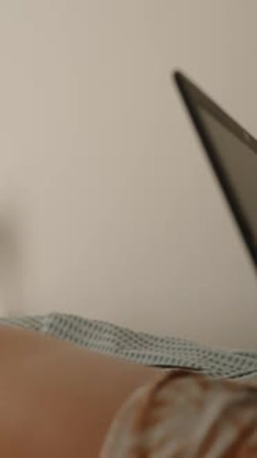 Legs and Feet Relaxing on a Bed