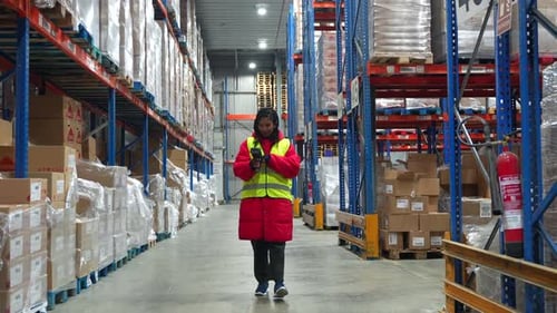 Female Warehouse Worker Scanning Barcodes in Cold Storage Facility