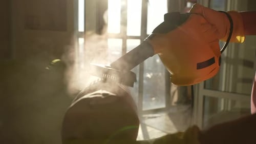 Closeup Side View of Unrecognizable Professional Cleaner Male in Protective Gloves Cleaning White