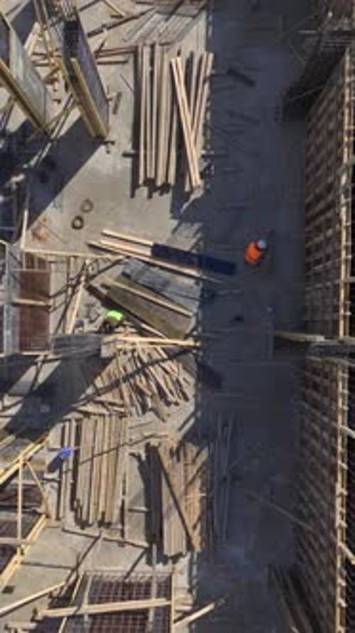 Vertical Video Workers Build Walls on an Active Construction Site Showcasing the Dedication Behind