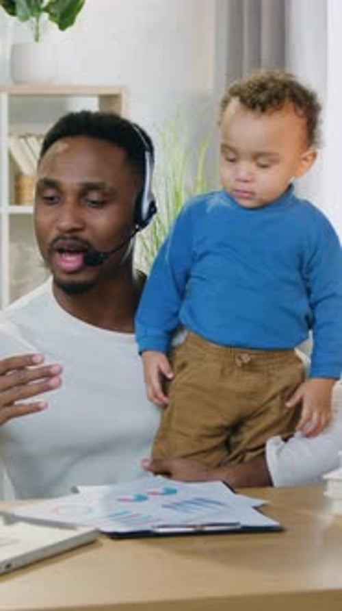 Lovely Little Boy Interfering to Work His Experienced Positive Loving African American Father Which