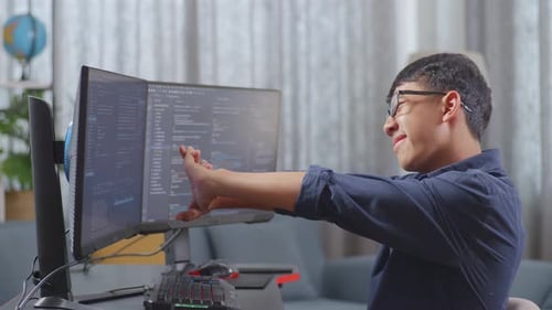 Asian Boy Programmer Stretching While Creating Software Engineer Developing App, Program