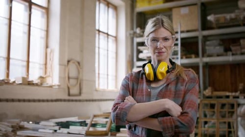 Female carpenter in workshop smiling confidently at the camera small business concept