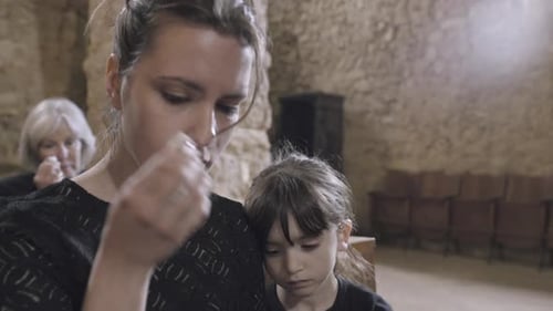 Mother with child at a funeral
