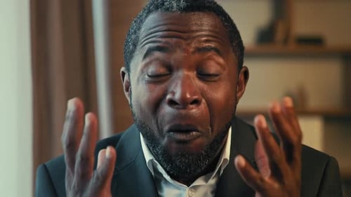 Man Reacts with Surprise, Smiles, and Laughs