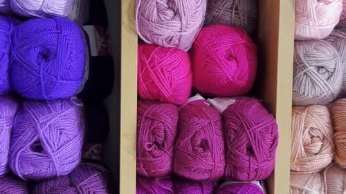 Closeup of Woolen Threads of Different Colors in a Store on a Shelf Vertical Video
