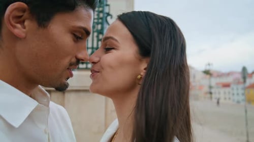 Happy Newlyweds Touching Noses at Urban Place Closeup. Enamoured Couple Embracing Together