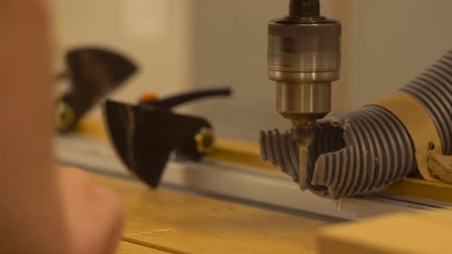 Drilling holes in wood block with a machine