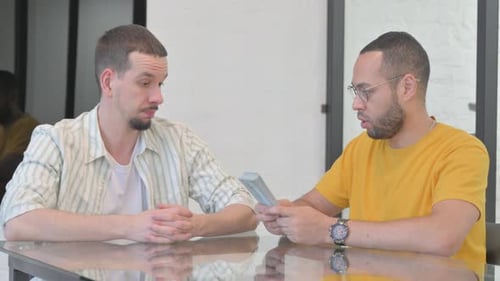 Mixed Race Man Paying Money in Office