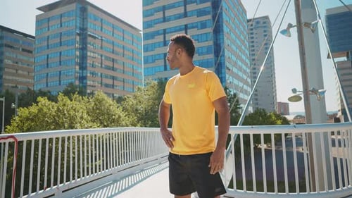 Handsome Man Pauses on Bridge in City