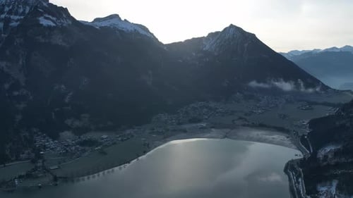 Aerial video of village, snowy mountains and lakes in Tyrol, Austrian Alps, Austria