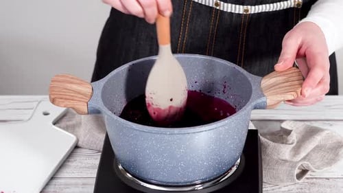 Stirring Blueberries in a Pot for Cooking