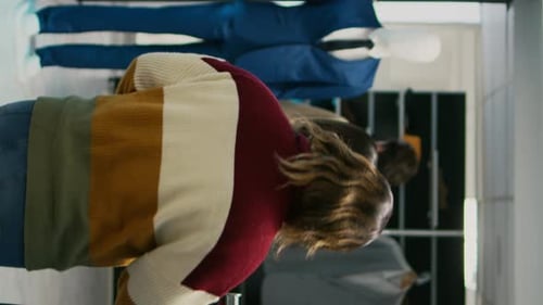 People Browse and Fold Clothes in Clothing Store