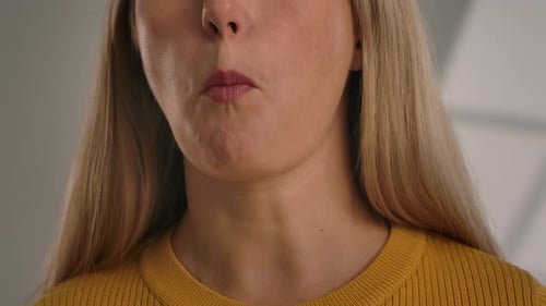Close Up of a Woman Eating a Rye Cracker with Her Hand
