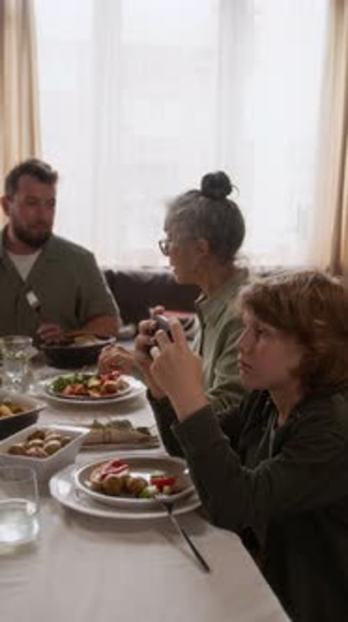 Family Meal with Child Using Phone