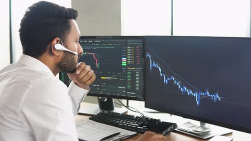 Side View of Smart Indian Crypto Trader Investor Analyst Broker Using Pc Analyzing Digital